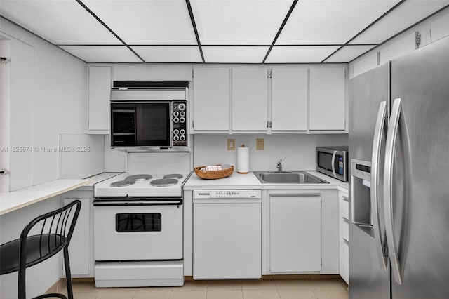 3701 N Country Club Dr Unit 2209, Aventura, FL 33180 - kitchen featuring appliances with stainless steel finishes, light countertops, white cabinetry, a paneled ceiling, and light tile patterned flooring