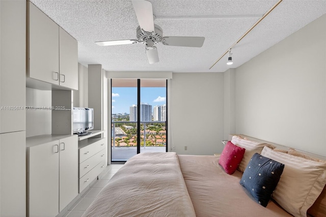 3701 N Country Club Dr Unit 2209, Aventura, FL 33180 - bedroom featuring access to outside, a textured ceiling, track lighting, ceiling fan, and light tile patterned flooring