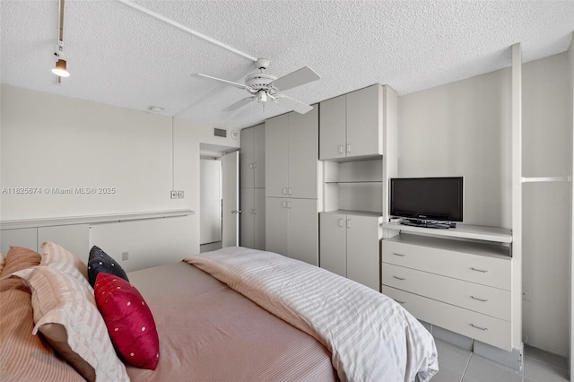 3701 N Country Club Dr Unit 2209, Aventura, FL 33180 - bedroom with a textured ceiling, light tile patterned floors, and a ceiling fan