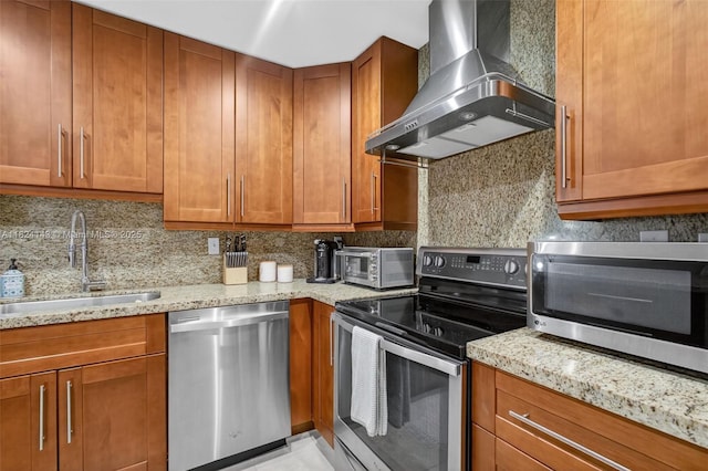 6401 SW 116th Ct Unit C, Miami, FL 33173 - kitchen with stainless steel appliances, wall chimney range hood, brown cabinets, light stone countertops, and tasteful backsplash
