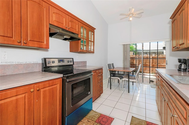 806 NE 214th Ln Unit 806-03, Miami, FL 33179 - kitchen featuring electric stove, under cabinet range hood, light tile patterned flooring, brown cabinetry, and ceiling fan