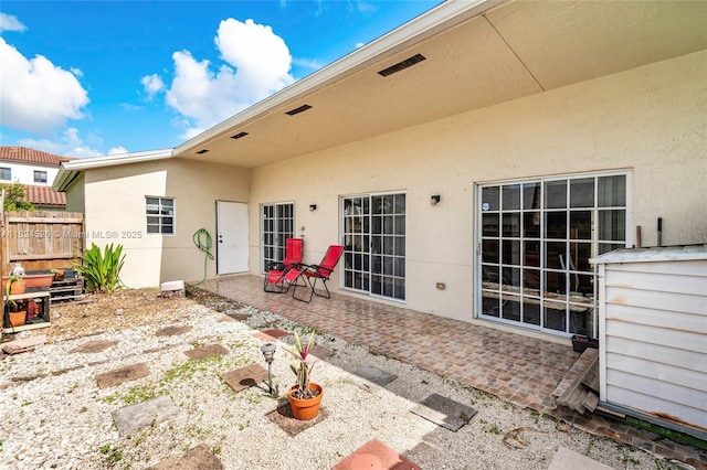 806 NE 214th Ln Unit 806-03, Miami, FL 33179 - rear view of house with a patio area and stucco siding