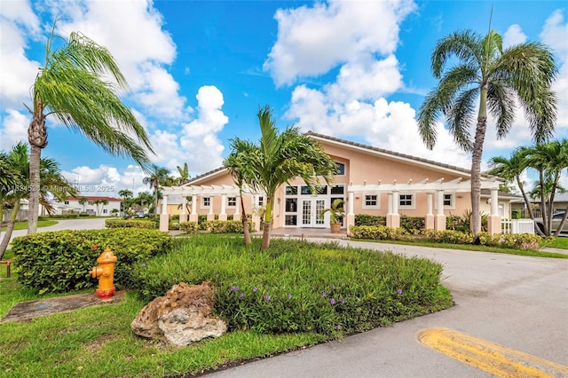 806 NE 214th Ln Unit 806-03, Miami, FL 33179 - view of front of property with french doors, stucco siding, and a pergola