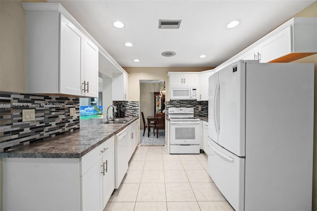 6905 NW 73rd St, Tamarac, FL 33321 - kitchen featuring white appliances, decorative backsplash, dark countertops, white cabinetry, and recessed lighting