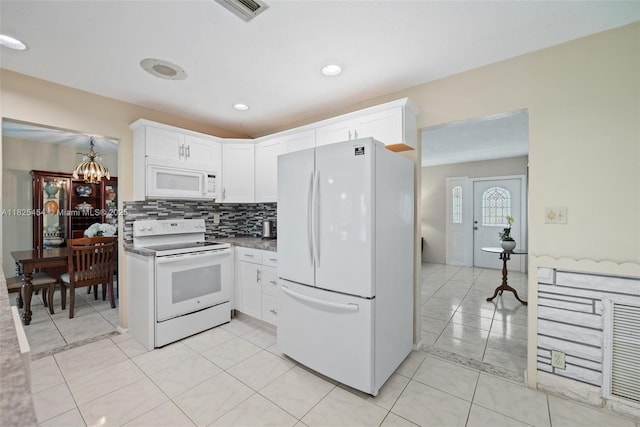 6905 NW 73rd St, Tamarac, FL 33321 - kitchen with white appliances, white cabinetry, decorative backsplash, a chandelier, and light tile patterned floors