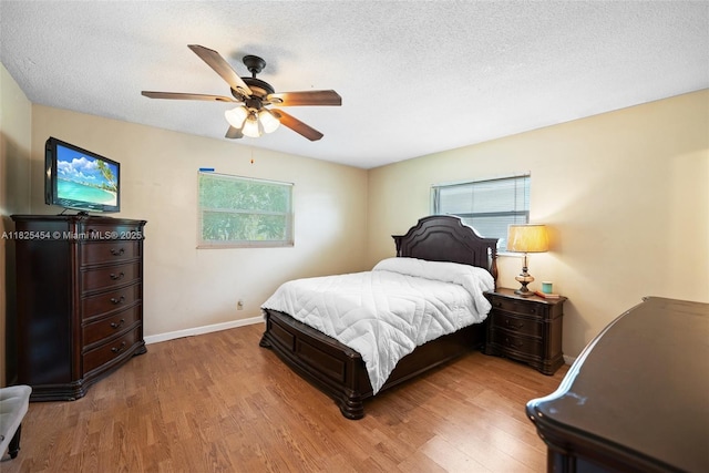 6905 NW 73rd St, Tamarac, FL 33321 - bedroom with multiple windows, wood finished floors, a textured ceiling, and ceiling fan