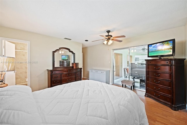 6905 NW 73rd St, Tamarac, FL 33321 - bedroom featuring light wood-type flooring, ensuite bath, and a ceiling fan