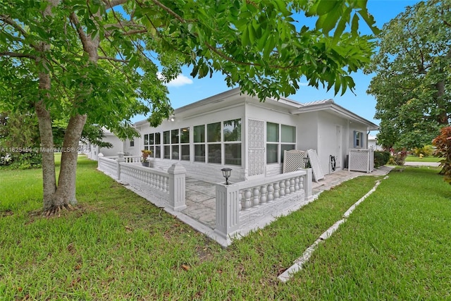 6905 NW 73rd St, Tamarac, FL 33321 - view of home's exterior featuring a lawn and stucco siding
