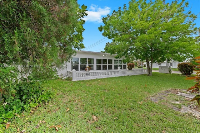 6905 NW 73rd St, Tamarac, FL 33321 - rear view of house with a lawn and a sunroom