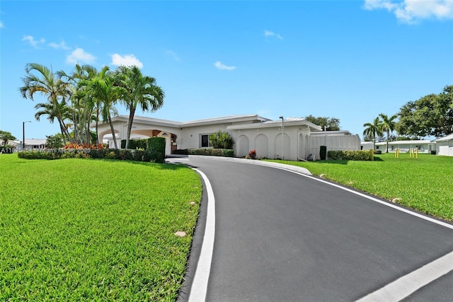 6905 NW 73rd St, Tamarac, FL 33321 - single story home featuring stucco siding, a front yard, and asphalt driveway