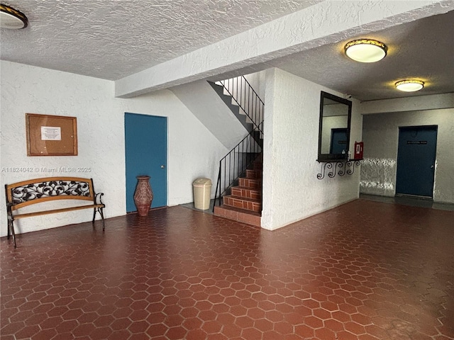 1635 W 44th Pl Unit 509, Hialeah, FL 33012 - basement with stairway, a textured wall, tile patterned floors, and a textured ceiling