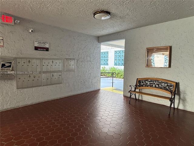 1635 W 44th Pl Unit 509, Hialeah, FL 33012 - interior space with mail area, a textured wall, and a textured ceiling