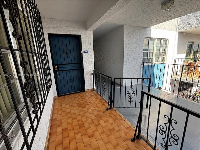 1635 W 44th Pl Unit 509, Hialeah, FL 33012 - view of exterior entry with stucco siding and a balcony