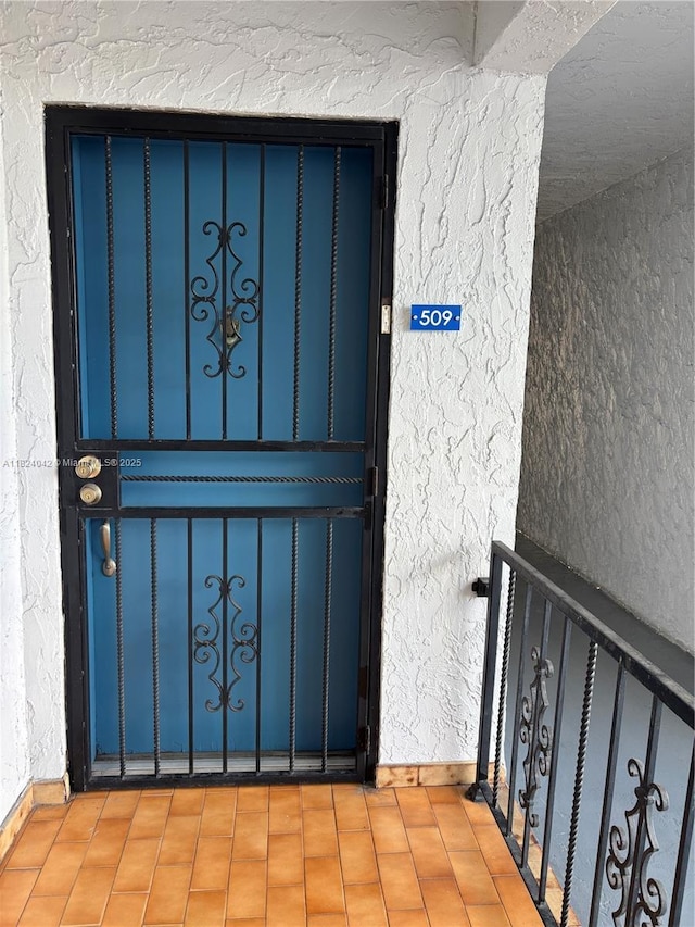 1635 W 44th Pl Unit 509, Hialeah, FL 33012 - doorway to property with stucco siding and a balcony