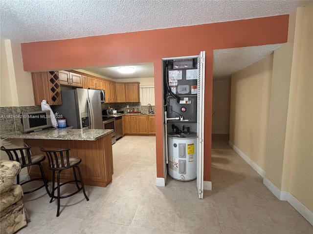 1635 W 44th Pl Unit 509, Hialeah, FL 33012 - kitchen featuring a peninsula, backsplash, stainless steel appliances, brown cabinets, and a breakfast bar