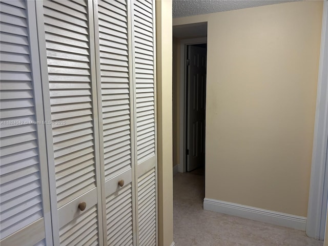 1635 W 44th Pl Unit 509, Hialeah, FL 33012 - corridor featuring light tile patterned floors and a textured ceiling