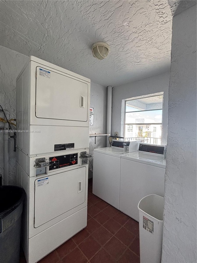 1635 W 44th Pl Unit 509, Hialeah, FL 33012 - community laundry featuring stacked washer / dryer, dark tile patterned flooring, independent washer and dryer, a textured ceiling, and a textured wall