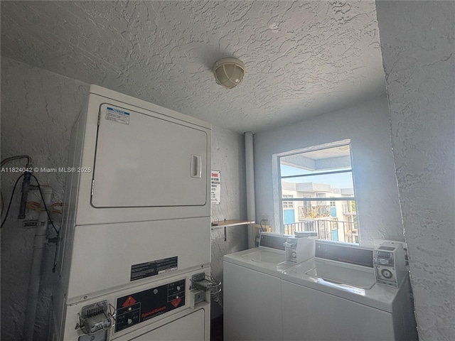 1635 W 44th Pl Unit 509, Hialeah, FL 33012 - laundry area with estacked washer and dryer, a textured wall, and a textured ceiling