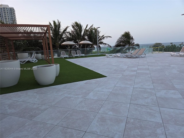 7135 Collins Ave Unit 424, Miami Beach, FL 33141 - patio terrace at dusk featuring a pergola and a patio area