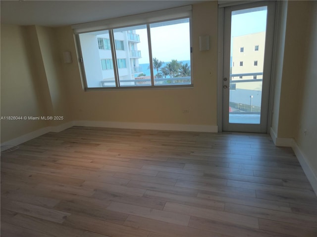 7135 Collins Ave Unit 424, Miami Beach, FL 33141 - spare room with wood finished floors and baseboards