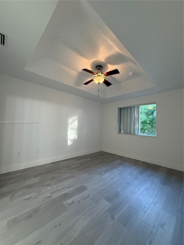 2452 SE 14th Ave Unit 284, Homestead, FL 33035 - unfurnished room with a tray ceiling, dark wood-style flooring, and ceiling fan