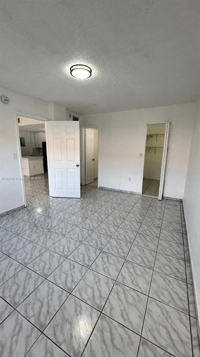 8095 NW 8th St Unit 103, Miami, FL 33126 - unfurnished room featuring a textured ceiling
