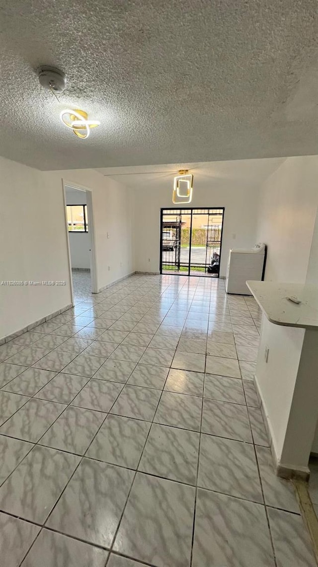 8095 NW 8th St Unit 103, Miami, FL 33126 - unfurnished room with a textured ceiling