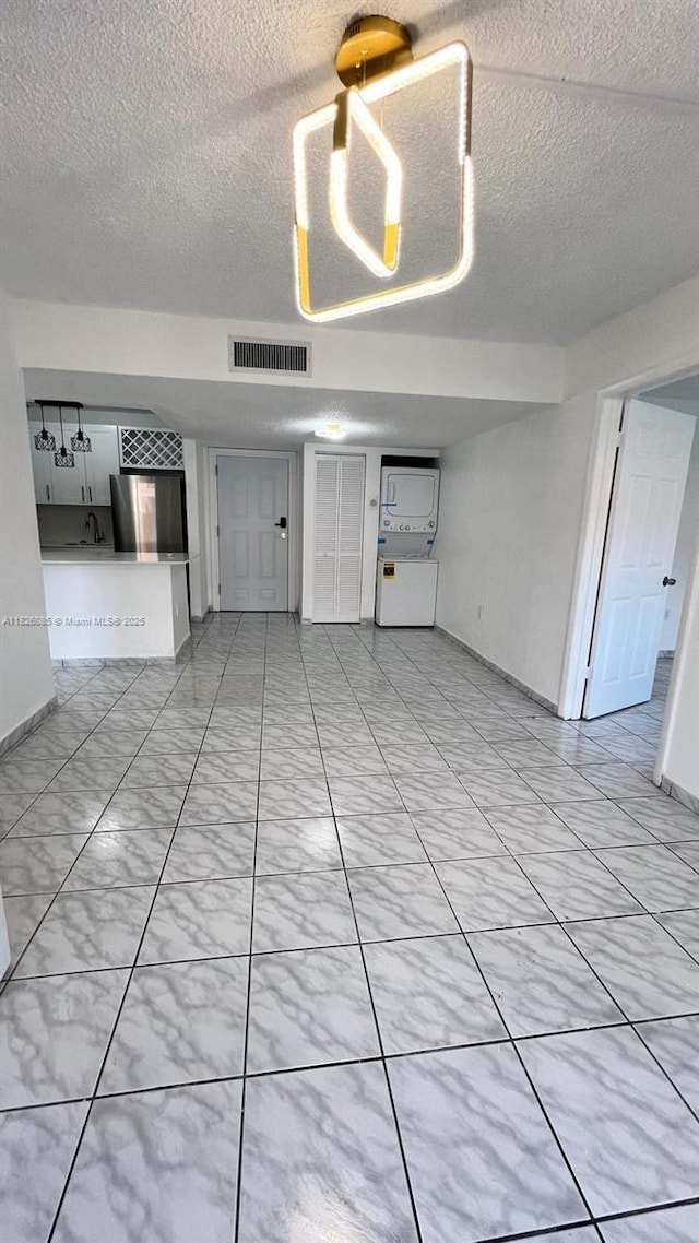 8095 NW 8th St Unit 103, Miami, FL 33126 - spare room featuring a textured ceiling and baseboards