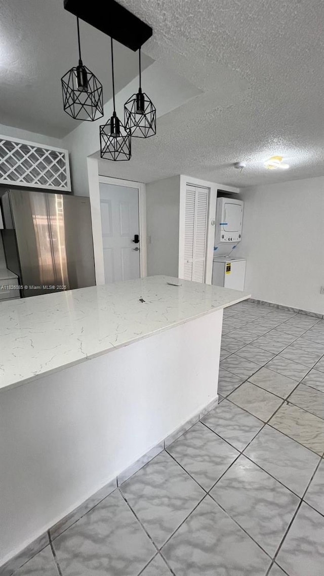 8095 NW 8th St Unit 103, Miami, FL 33126 - kitchen featuring a textured ceiling and light stone counters