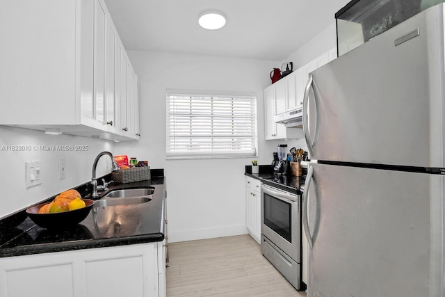 631 Euclid Ave Unit 8, Miami Beach, FL 33139 - kitchen with stainless steel appliances, under cabinet range hood, white cabinets, and light wood-style flooring