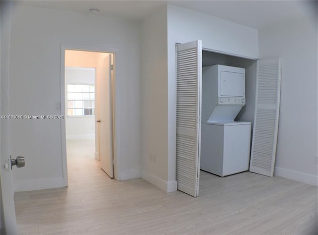 631 Euclid Ave Unit 8, Miami Beach, FL 33139 - laundry room with stacked washer and clothes dryer and light wood finished floors