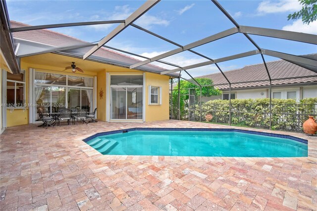 2694 Oakbrook Dr, Weston, FL 33332 - outdoor pool with a patio area, ceiling fan, outdoor dining area, and glass enclosure
