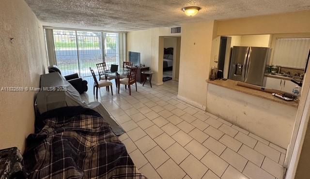8841 W Flagler St Unit 108, Miami, FL 33174 - living room with a textured ceiling and light tile patterned floors