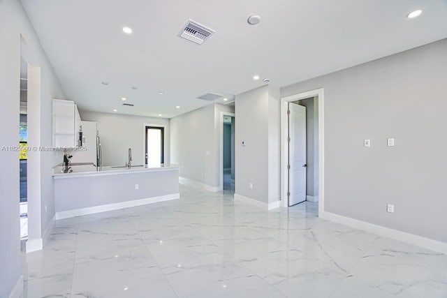 817/819 Eisenhower Blvd, Lehigh Acres, FL 33974 - unfurnished living room with recessed lighting and light marble finish flooring