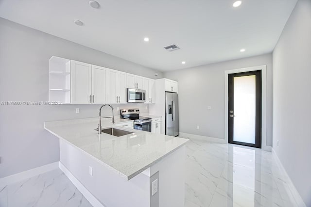 817/819 Eisenhower Blvd, Lehigh Acres, FL 33974 - kitchen with appliances with stainless steel finishes, light marble finish flooring, open shelves, recessed lighting, and white cabinetry
