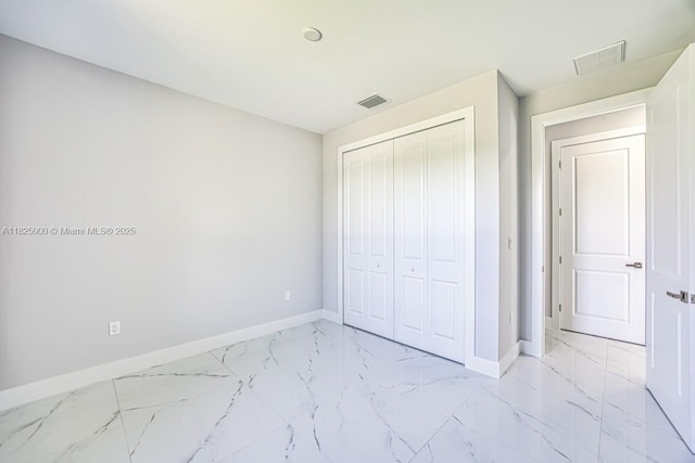 817/819 Eisenhower Blvd, Lehigh Acres, FL 33974 - unfurnished bedroom with light marble finish flooring and a closet