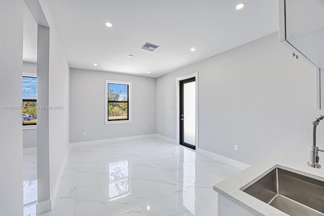 817/819 Eisenhower Blvd, Lehigh Acres, FL 33974 - unfurnished room with plenty of natural light, light marble finish flooring, and recessed lighting