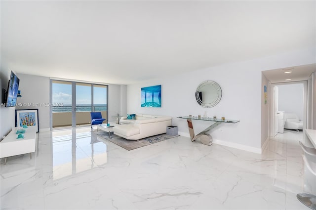 5555 Collins Ave Unit 7N, Miami Beach, FL 33140 - living room featuring a water view, marble tiled flooring, and floor to ceiling windows