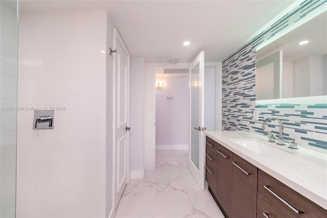 5555 Collins Ave Unit 7N, Miami Beach, FL 33140 - bathroom with vanity, marble finish flooring, recessed lighting, and backsplash