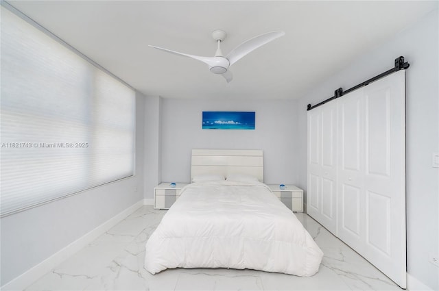 5555 Collins Ave Unit 7N, Miami Beach, FL 33140 - bedroom featuring a barn door, light marble finish floors, and a ceiling fan