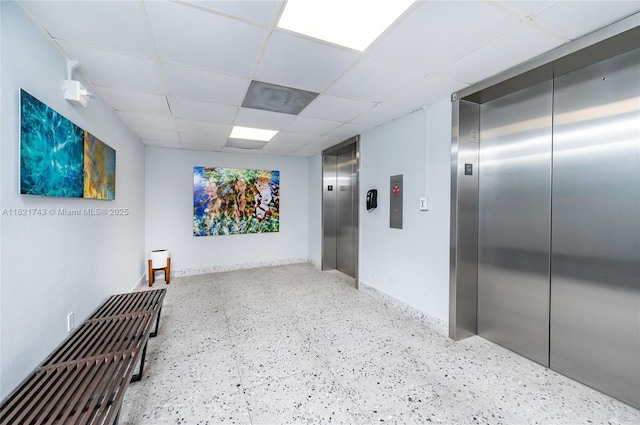 5555 Collins Ave Unit 7N, Miami Beach, FL 33140 - hallway featuring elevator and a paneled ceiling