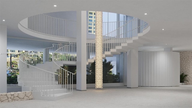 5555 Collins Ave Unit 7N, Miami Beach, FL 33140 - common area with stairs, a towering ceiling, recessed lighting, and wallpapered walls