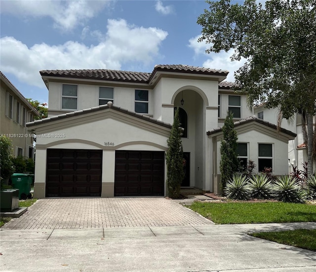 16546 SW 39th St, Miramar, FL 33027 - mediterranean / spanish-style house featuring a tiled roof, decorative driveway, a garage, and stucco siding