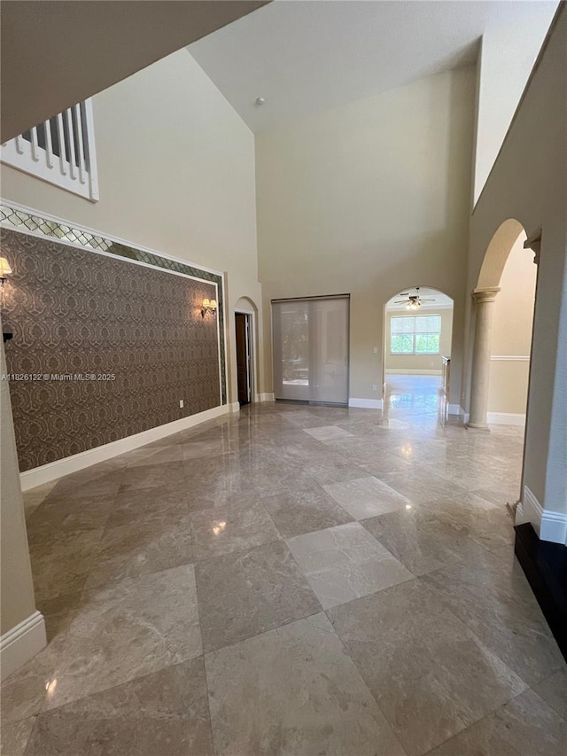 16546 SW 39th St, Miramar, FL 33027 - unfurnished living room featuring arched walkways, a towering ceiling, and ceiling fan