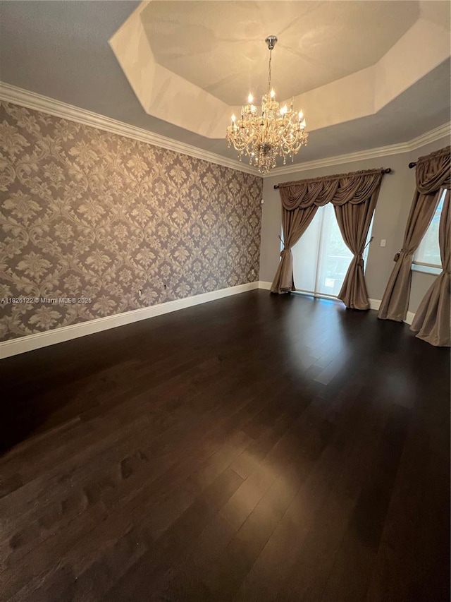 16546 SW 39th St, Miramar, FL 33027 - unfurnished room with a raised ceiling, a chandelier, dark wood-style floors, wallpapered walls, and ornamental molding