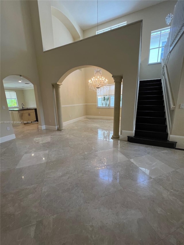 16546 SW 39th St, Miramar, FL 33027 - foyer entrance with plenty of natural light, a high ceiling, a chandelier, stairs, and arched walkways