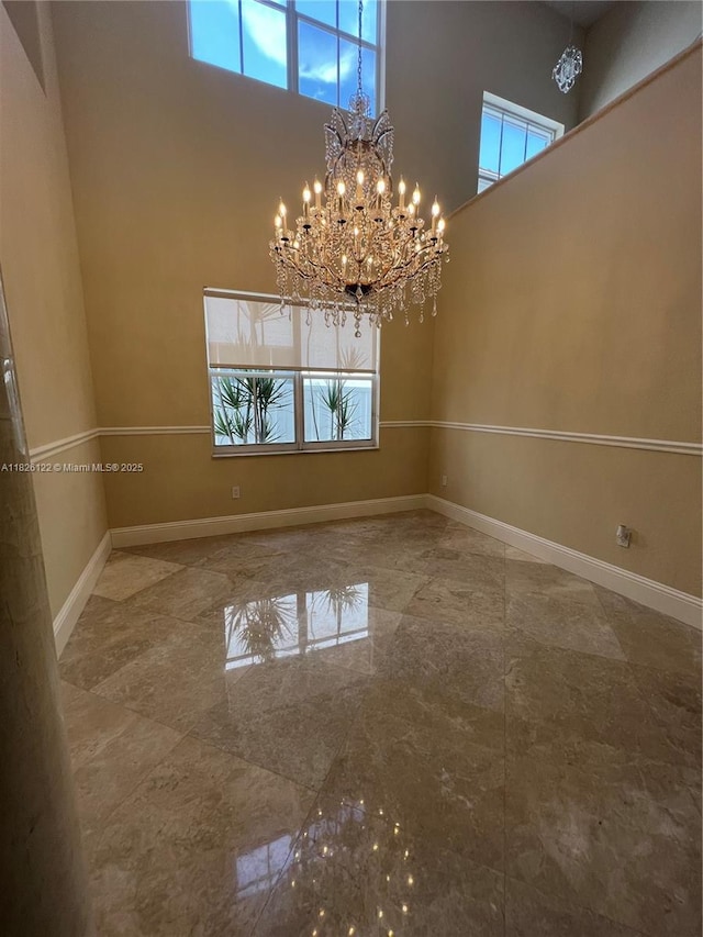 16546 SW 39th St, Miramar, FL 33027 - spare room featuring a high ceiling and a chandelier