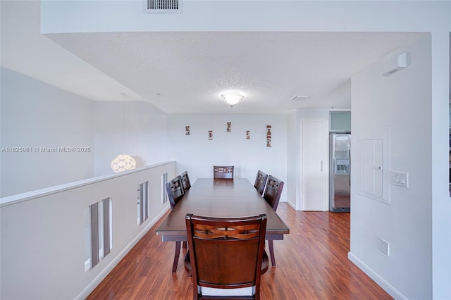 6440 NW 114th Ave Unit 434, Doral, FL 33178 - dining area with wood finished floors and a textured ceiling