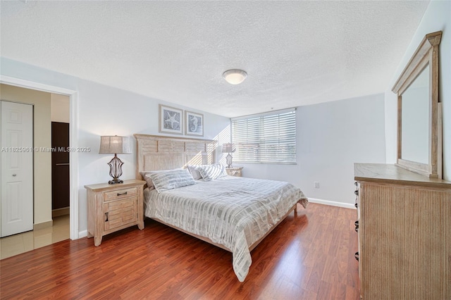 6440 NW 114th Ave Unit 434, Doral, FL 33178 - bedroom with a textured ceiling and wood finished floors
