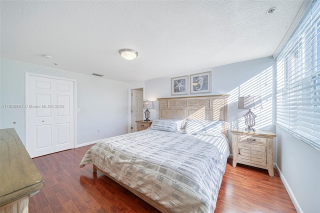 6440 NW 114th Ave Unit 434, Doral, FL 33178 - bedroom featuring wood finished floors and a textured ceiling